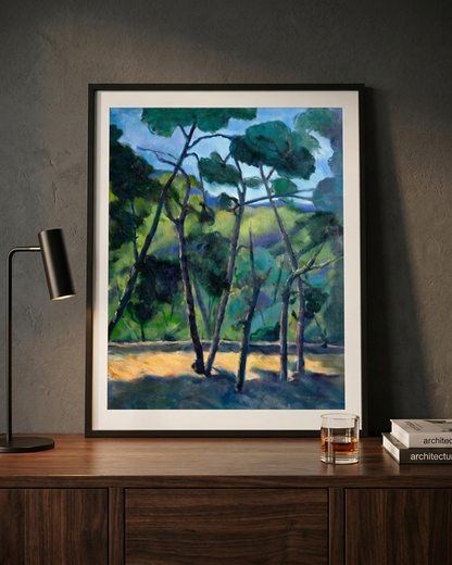 Close-up of Pines In Blue Light fine art paper print by Gwen Zhang in a black wood frame with the glass on a sideboard.